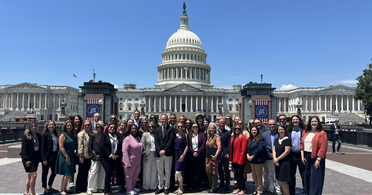 Group posing in front of U.S. Capitol